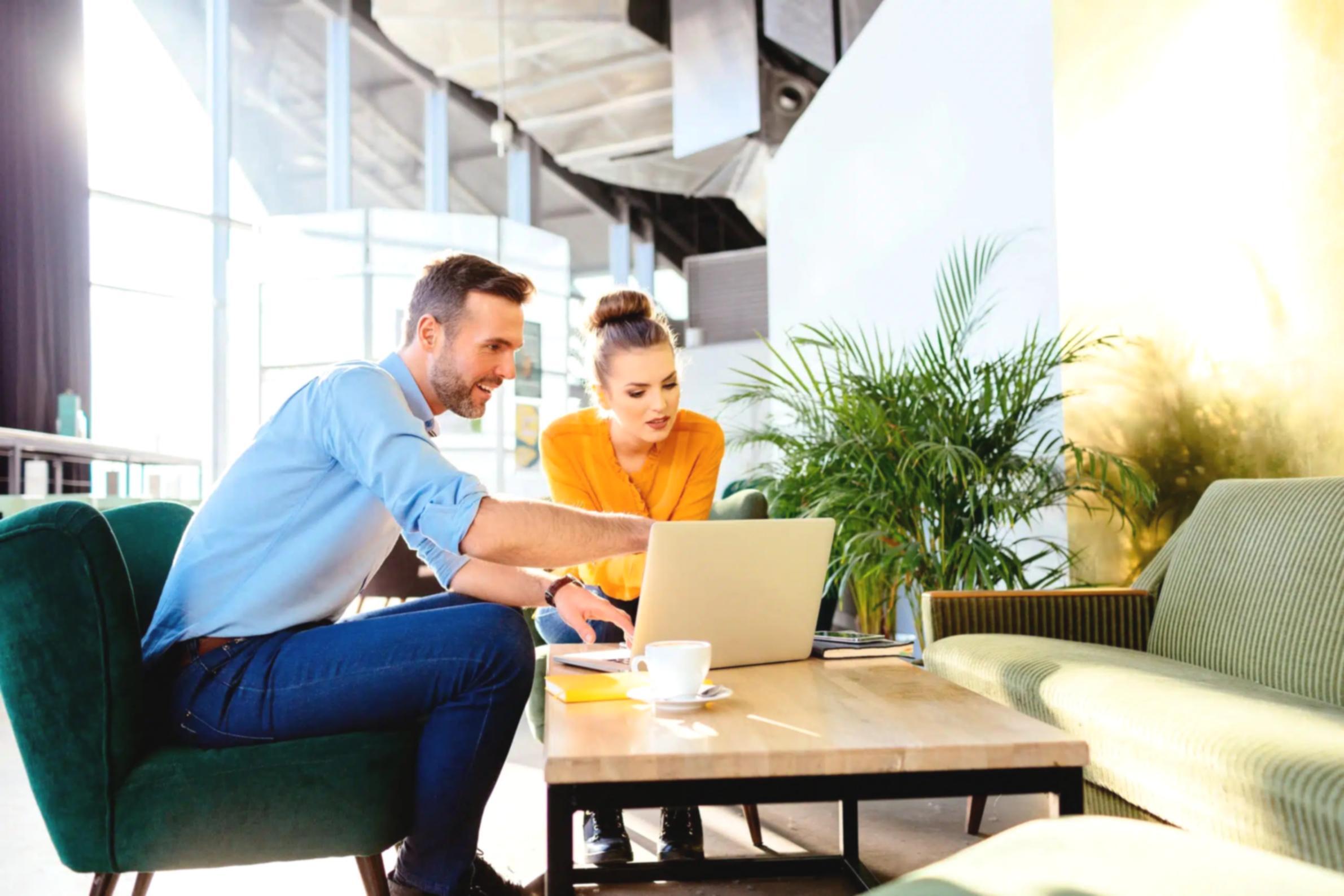 Finance professional reviewing presentation strategy with colleague